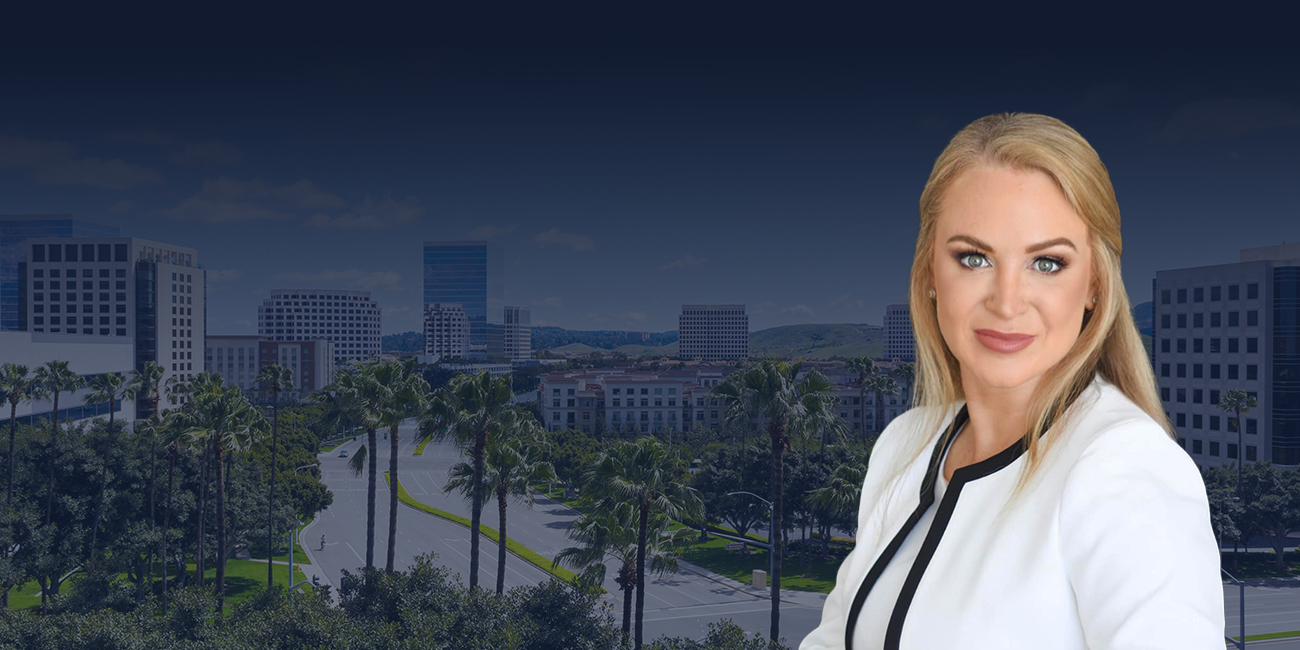 Lauren Johnson-Norris wearing a white blazer, with a cityscape and palm trees in the background.